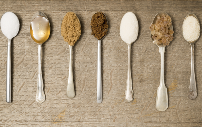 Spoons holding different types of sugar