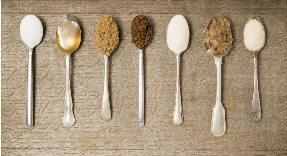 Spoons holding different types of sugar